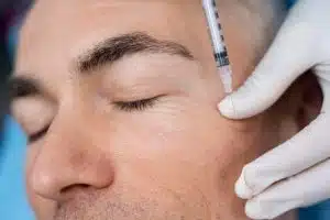 Anti-wrinkle injections, a form of cosmetic injectable neuromodulator, function by safely obstructing nerve signals to the muscles responsible for forming crow's feet, laugh lines, frown lines, forehead wrinkles, and chin dimpling.